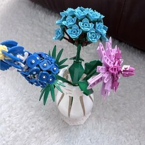 Brickcraft Floral Arrangement with Blue and Pink Blooms